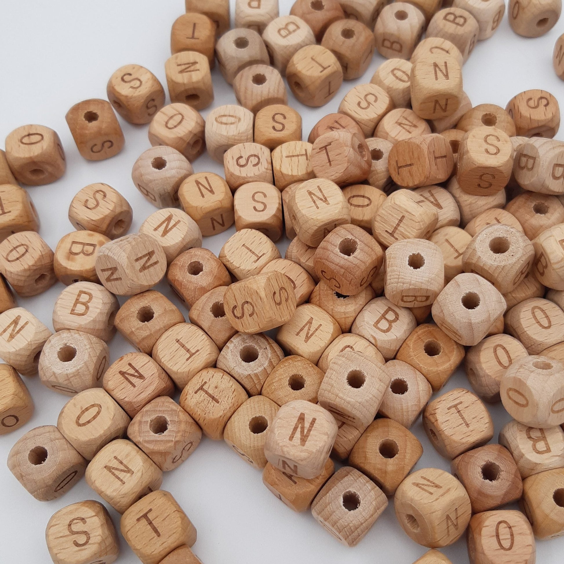 Wooden letter beads on a white background